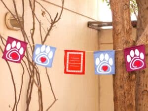 Pet Loss Mantra Flags hanging between two trees in garden: Best Cat Memorials: 25 Pet Memorial Ideas For Cat Owners